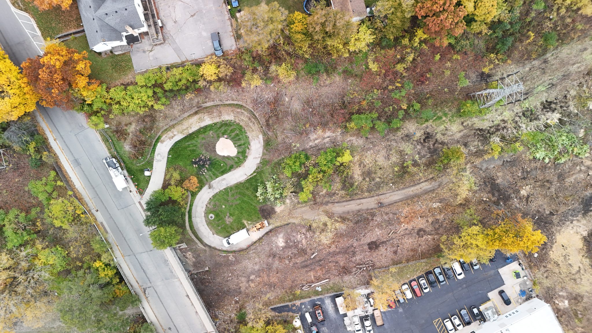 Drone image of initial construction at a switchback trail surrounded by autumnal leaves